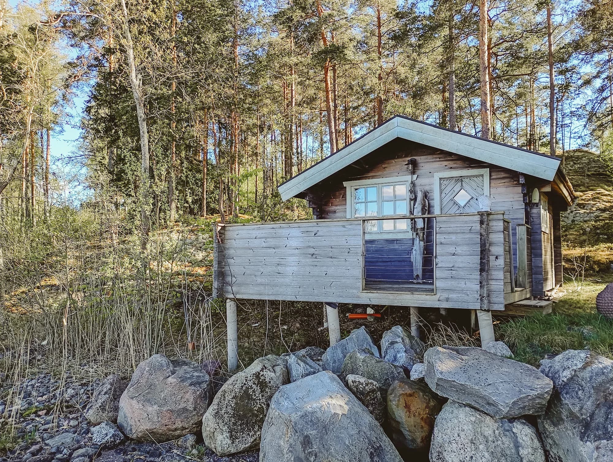 The Beach House on the rocks among the pines