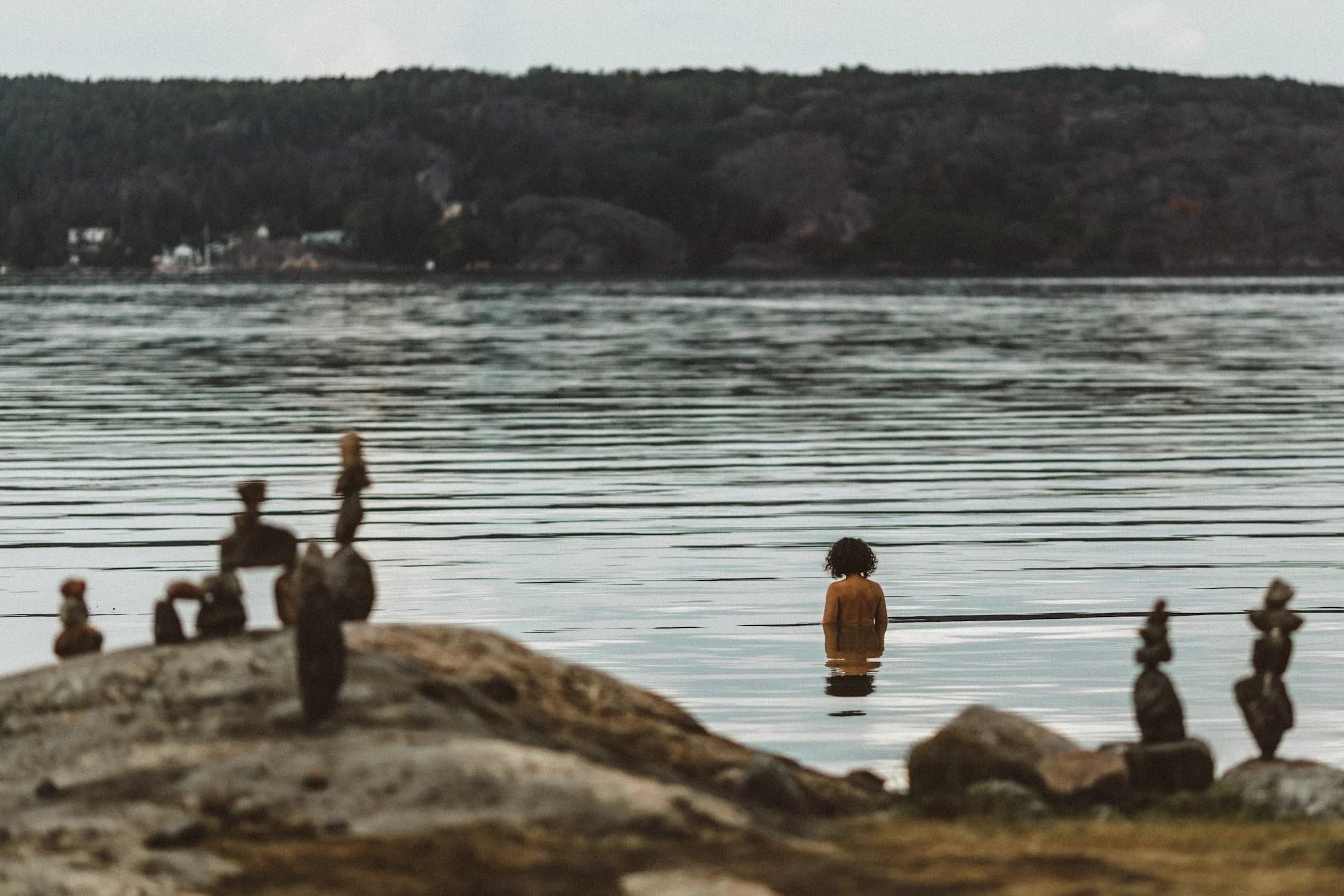 Stacked stones on the rocks at the water’s edge